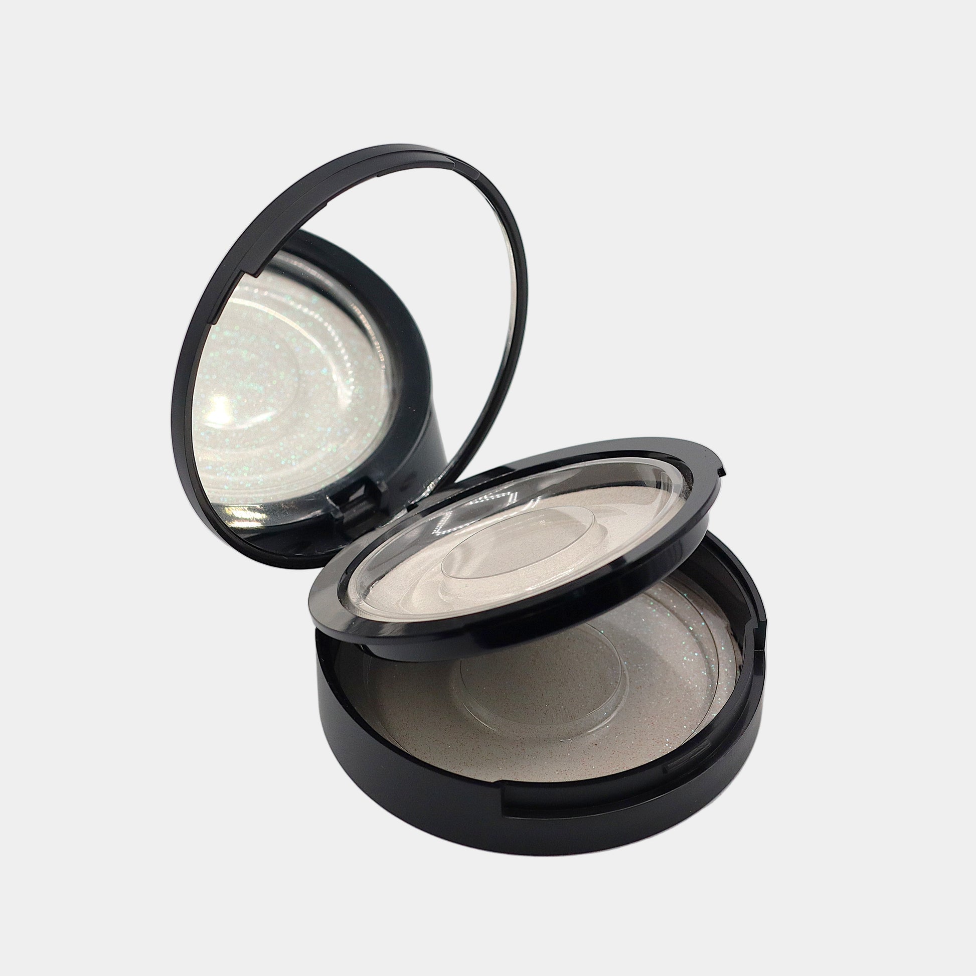 Angled view of mirrored strip lash compact open showing both trays opened